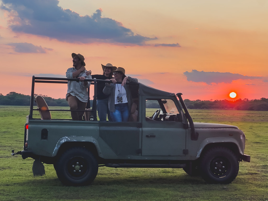 Pantanal sunset with a safari vehicle and travellers