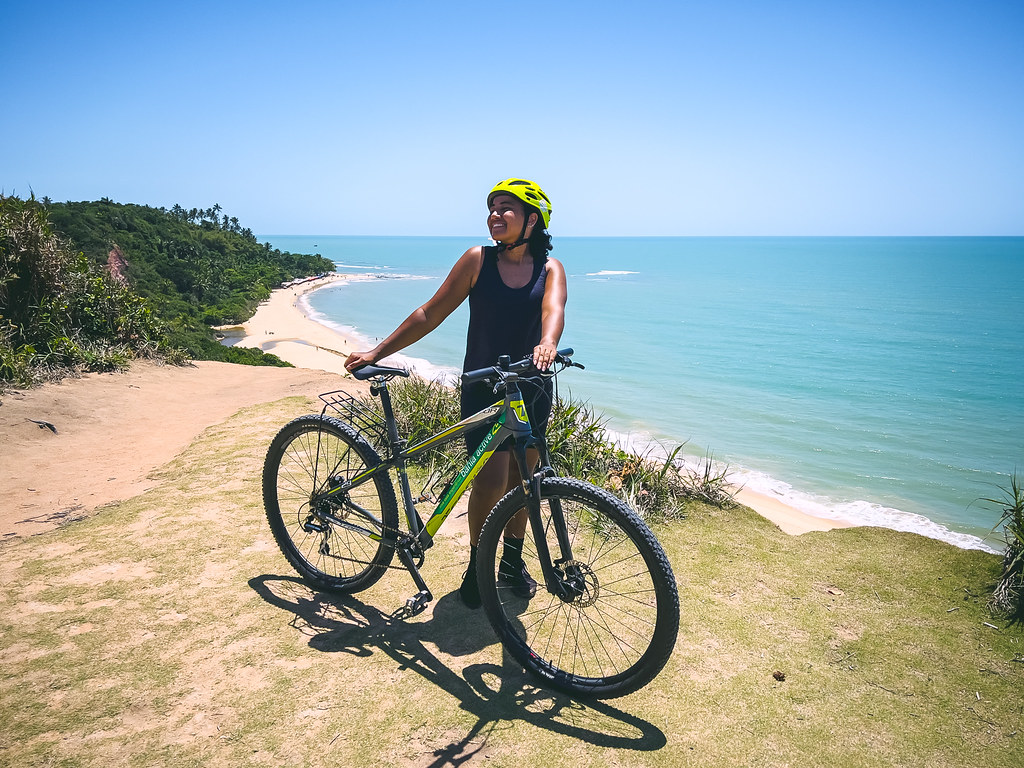 Cyclist on a coastal trail overlooking the sea